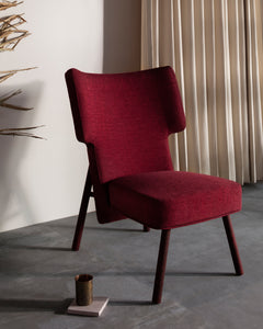 This modern lounge chair is made using solid wood, stained in different colors which gives it unique aesthetics.